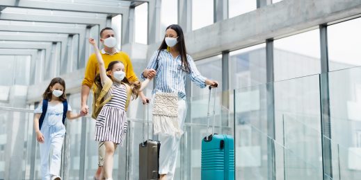 Family walking through boarding gate with luggage