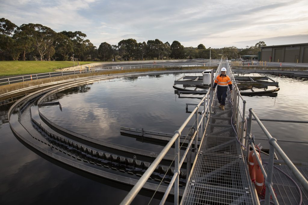 Worker in safety workwear inspecting a water system