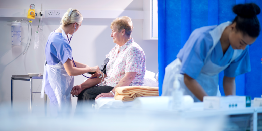 Elderly woman getting medically assessed in a hospital.