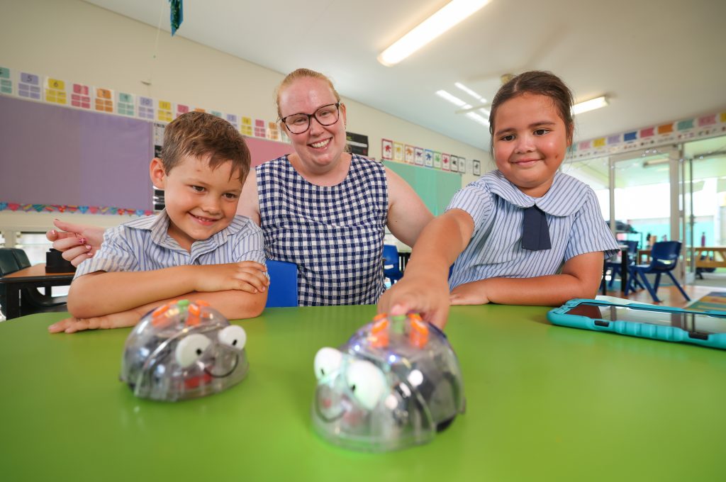 Two students and a teacher in a classroom