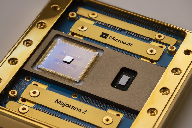A closeup of a mostly gold-colored chip with bits of blue showing. The names "Microsoft" and "Majorana 2" are visible.
