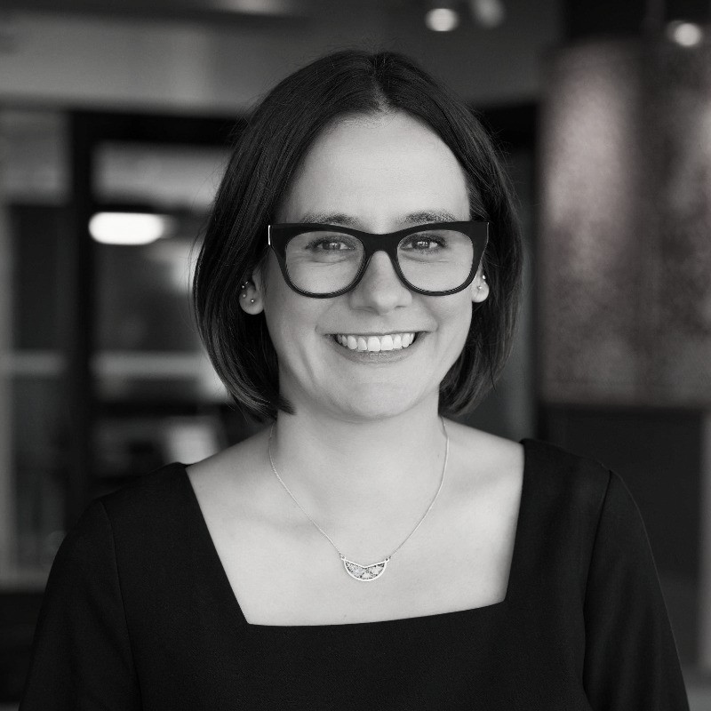 Close up of a woman with glasses and a black tshirt