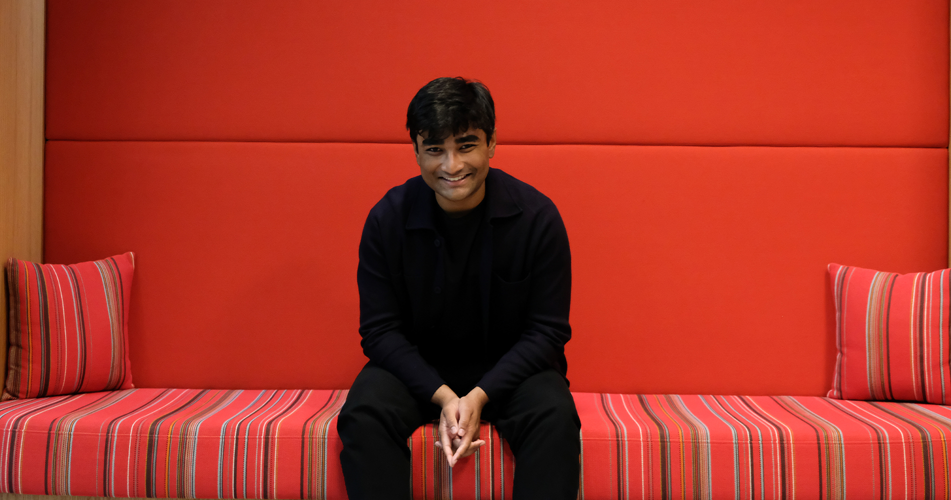 A man sits smiling