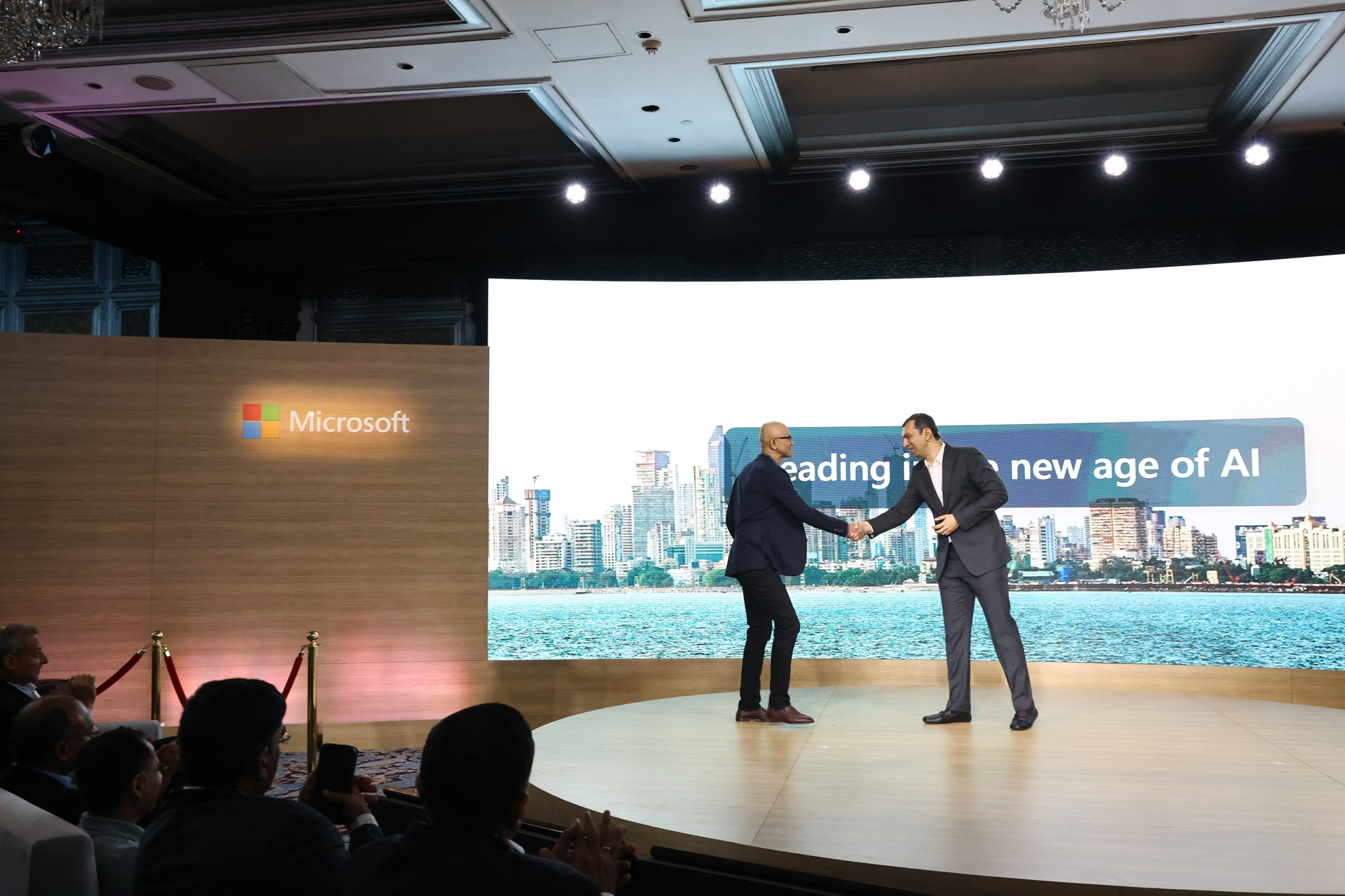 Two men shaking hands on stage