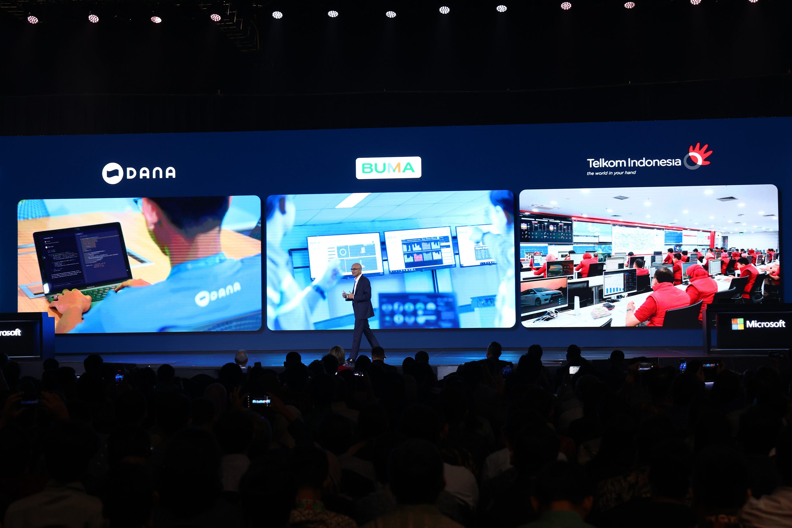 Man on stage with a big digital backdrop