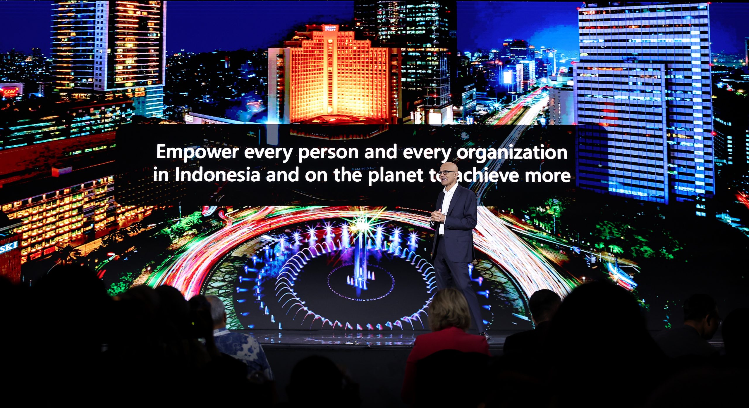 A man on a stage against the backdrop of Jakarta in Indonesia