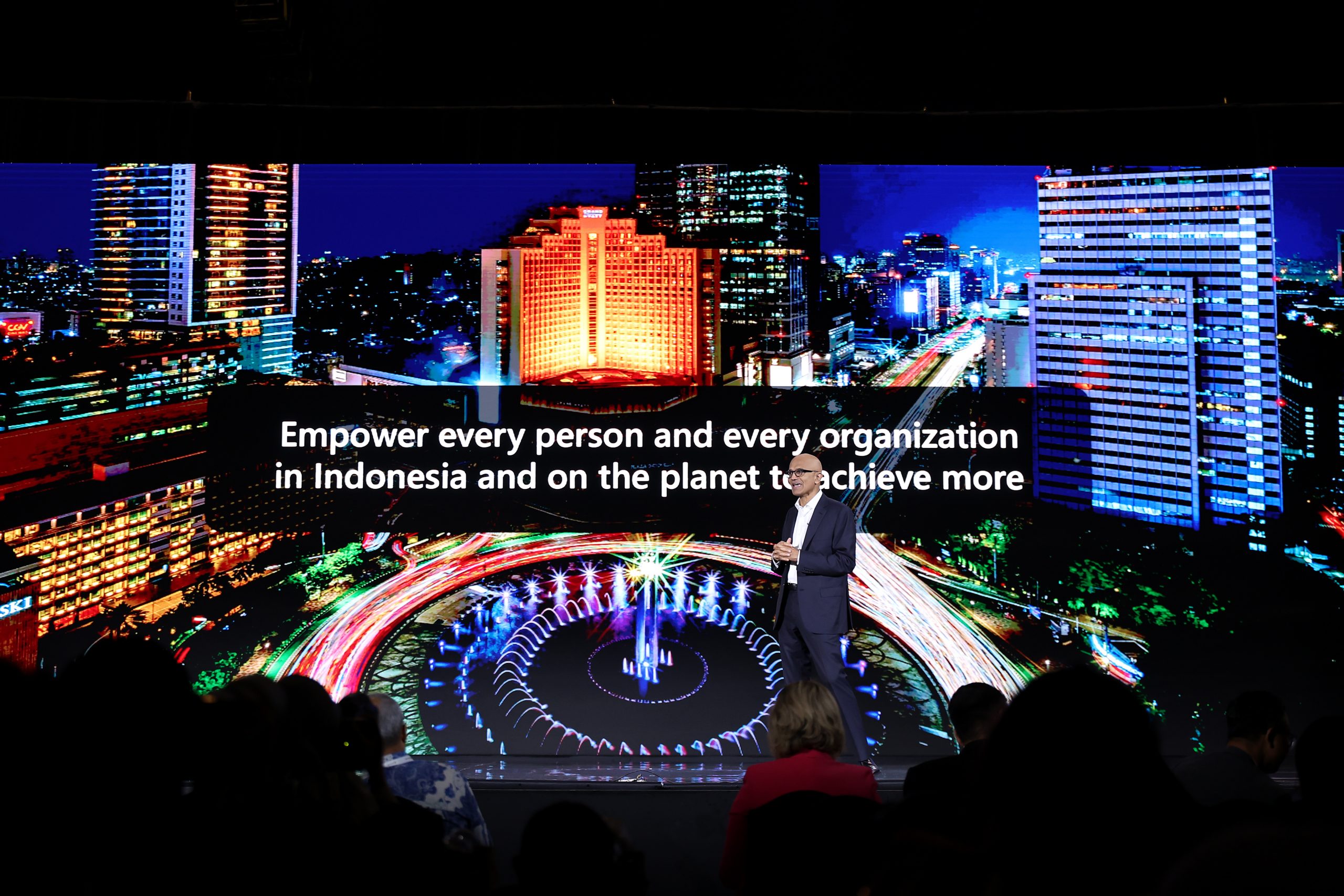A man on a stage against the backdrop of Jakarta in Indonesia