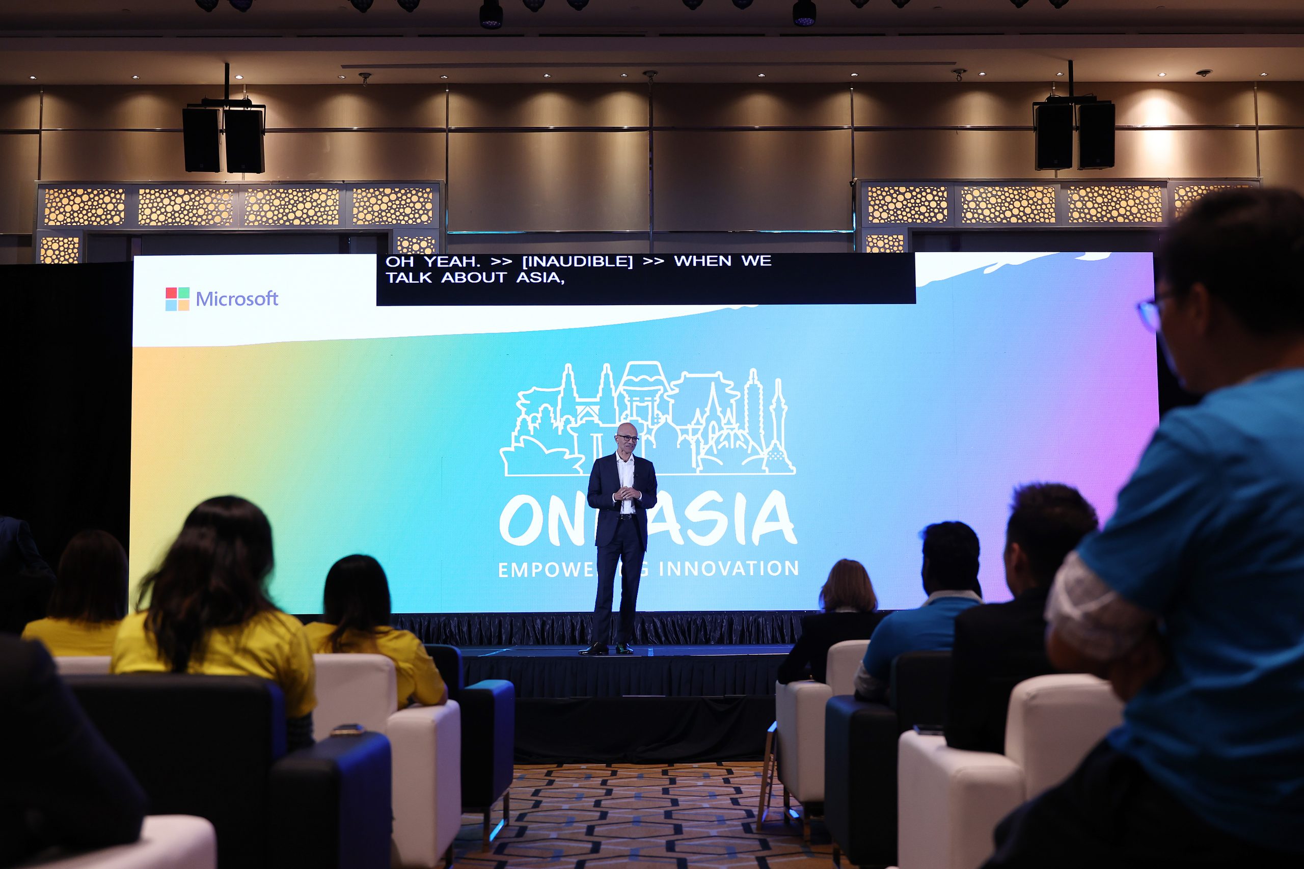 Man on stage talking to an audience