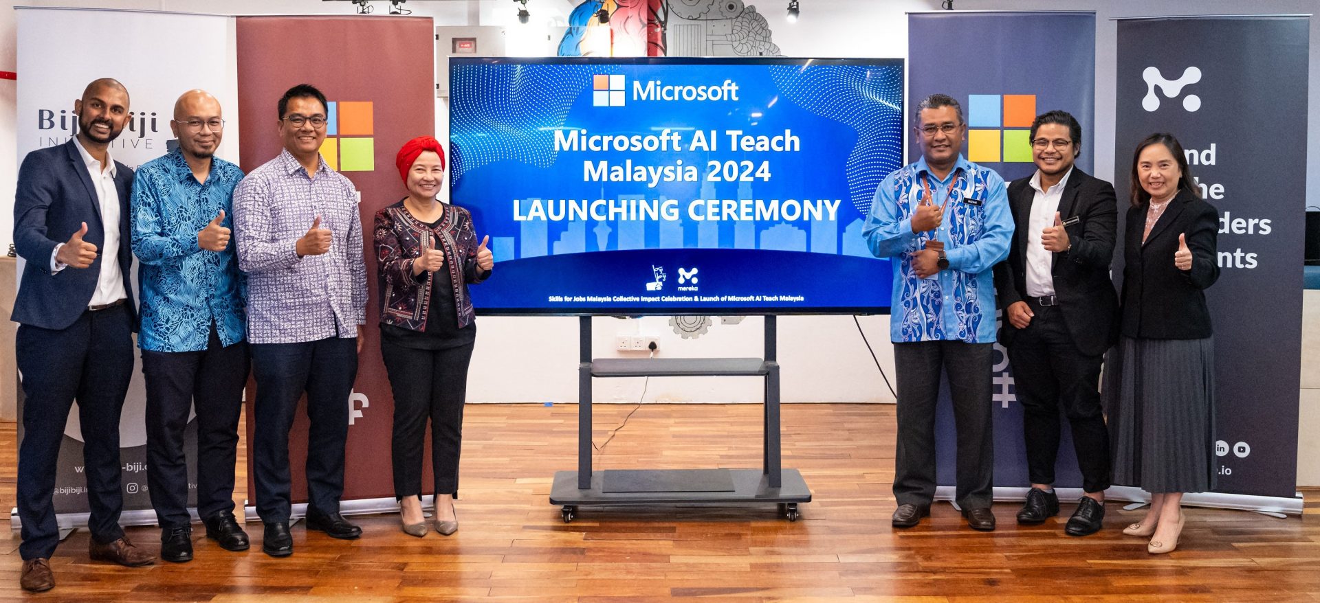 group of people standing on either side of a projector screen
