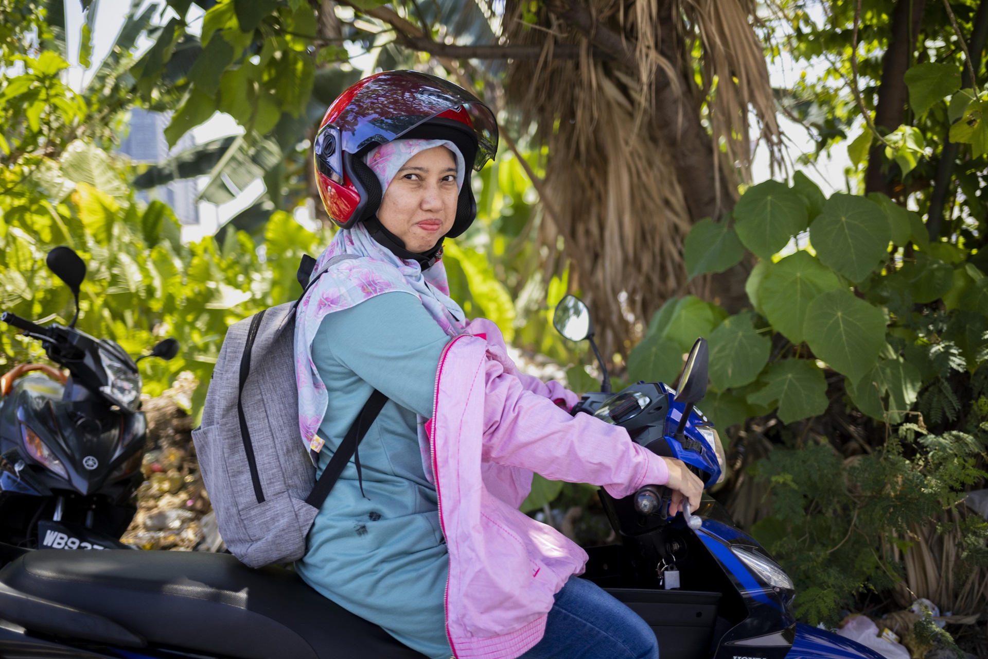 Woman in headscarf on scooter
