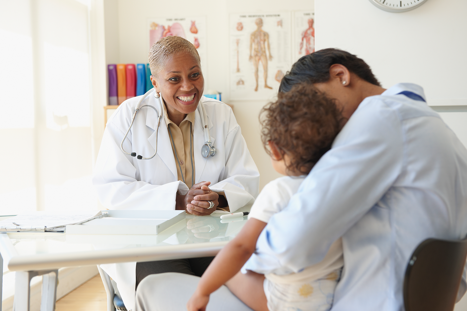 Female doctor consulting with a mother and her child in a clinic