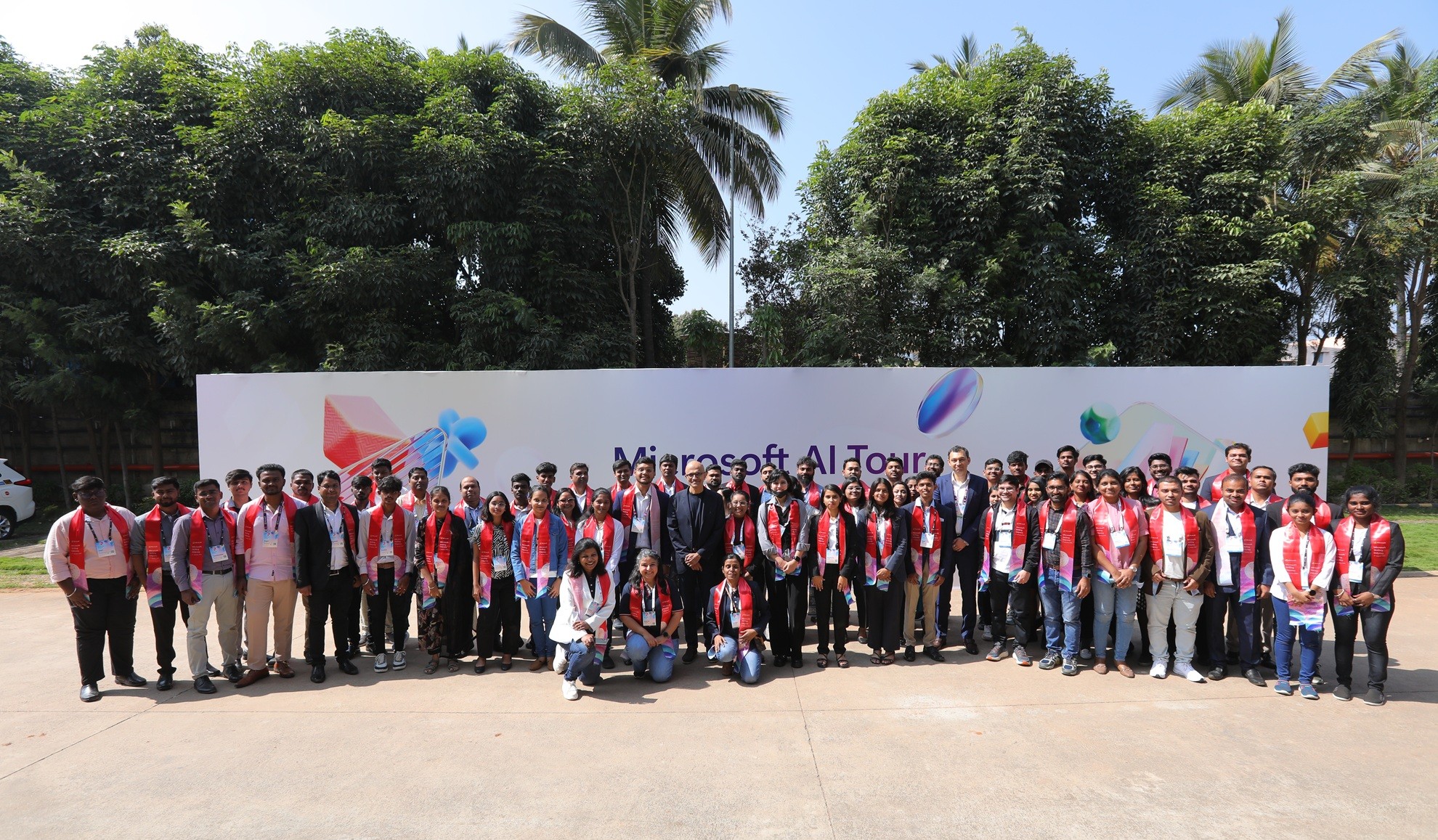 group of people posing with backdrop microsoft AI Tour