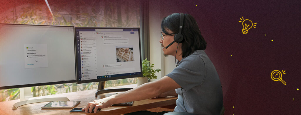 A man sits at a desk with a headset looking at two monitors; colorful background with shapes