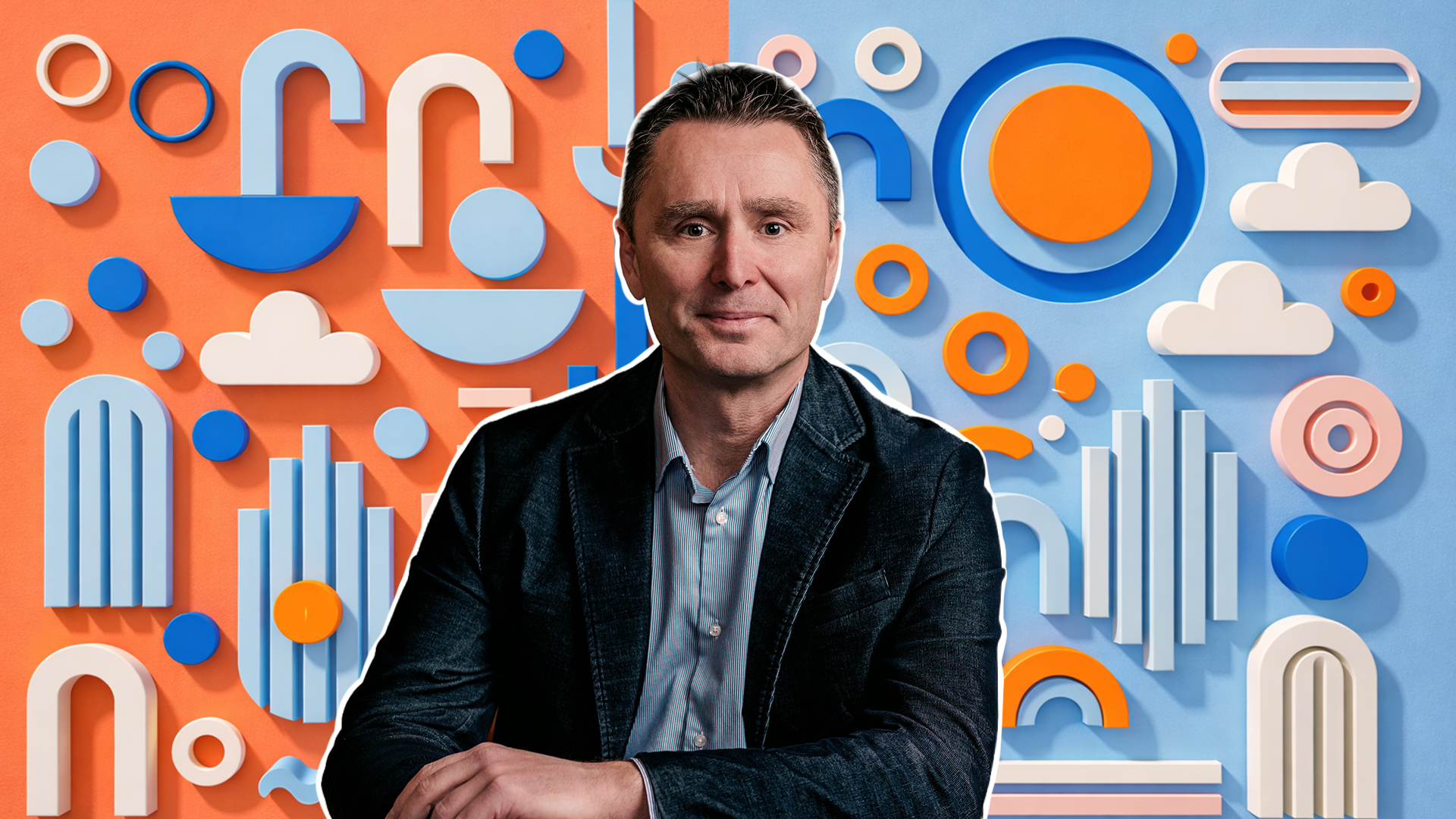 Slightly smiling man in dark jacket and blue and white button-down shirt in front of collage of colorful shapes.