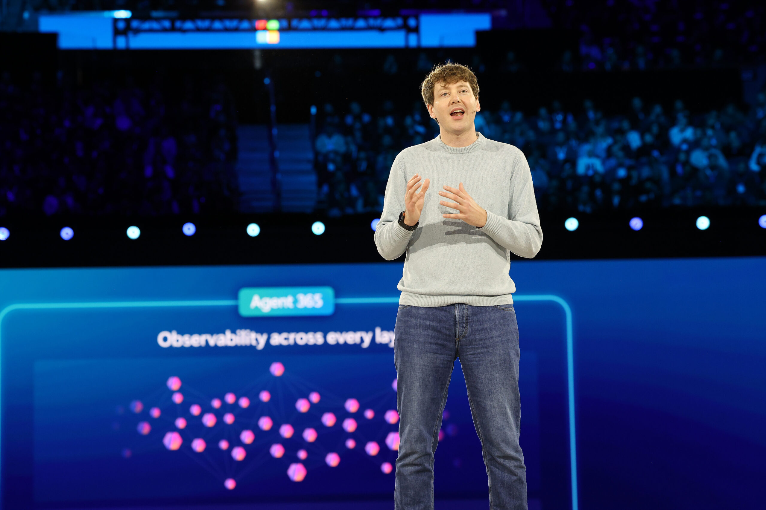 A man onstage at a business event.
