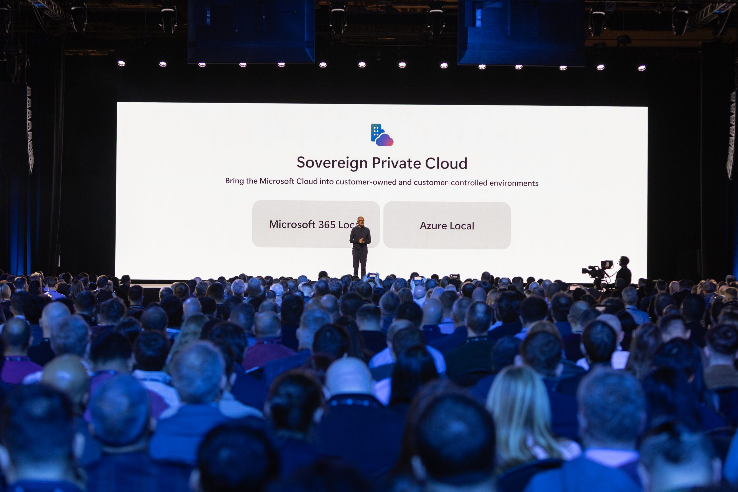 Satya Nadella standing in front of a Sovereign Private Cloud backdrop during discussions on AI transformation.