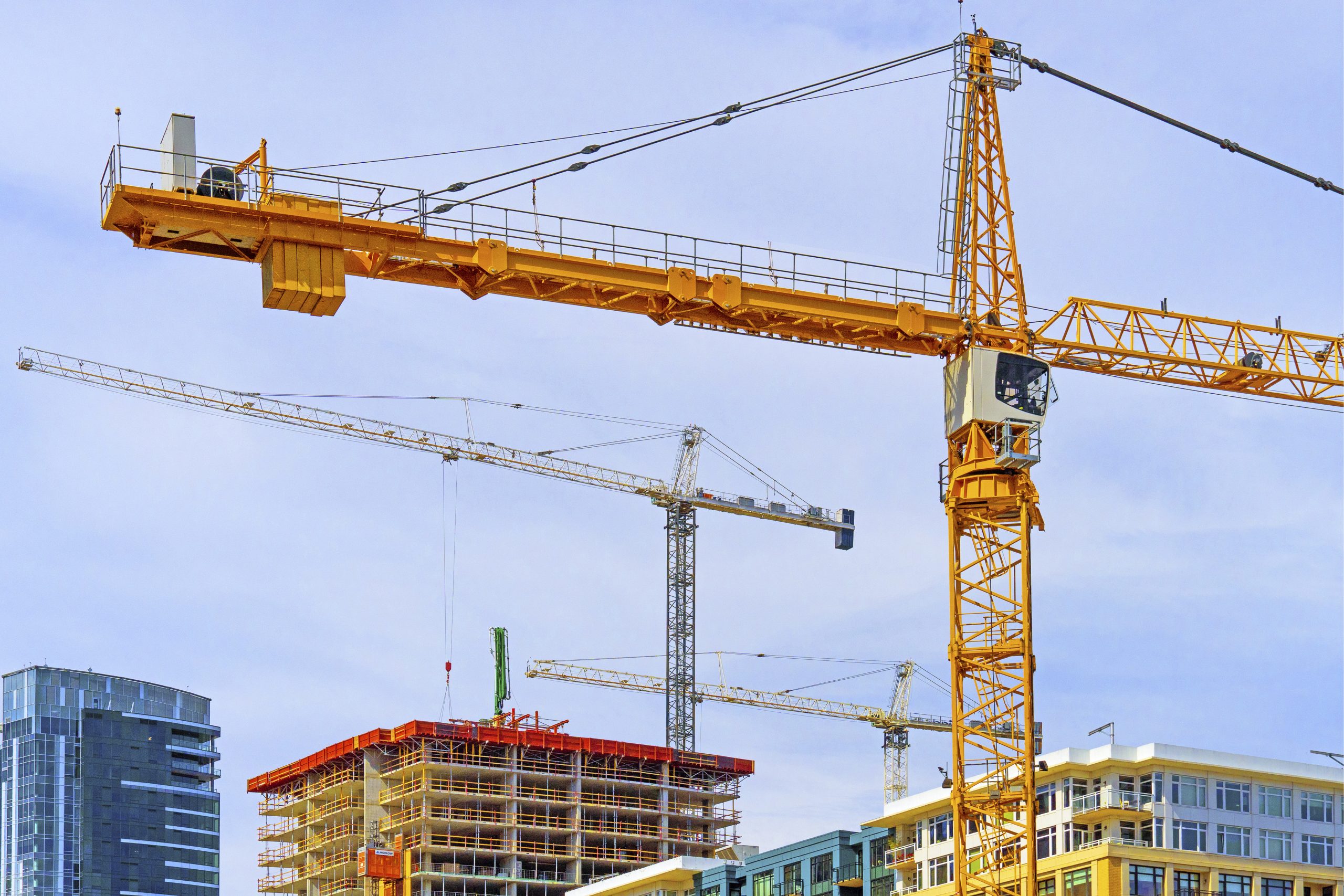 Construction cranes over downtown Seattle buildings.