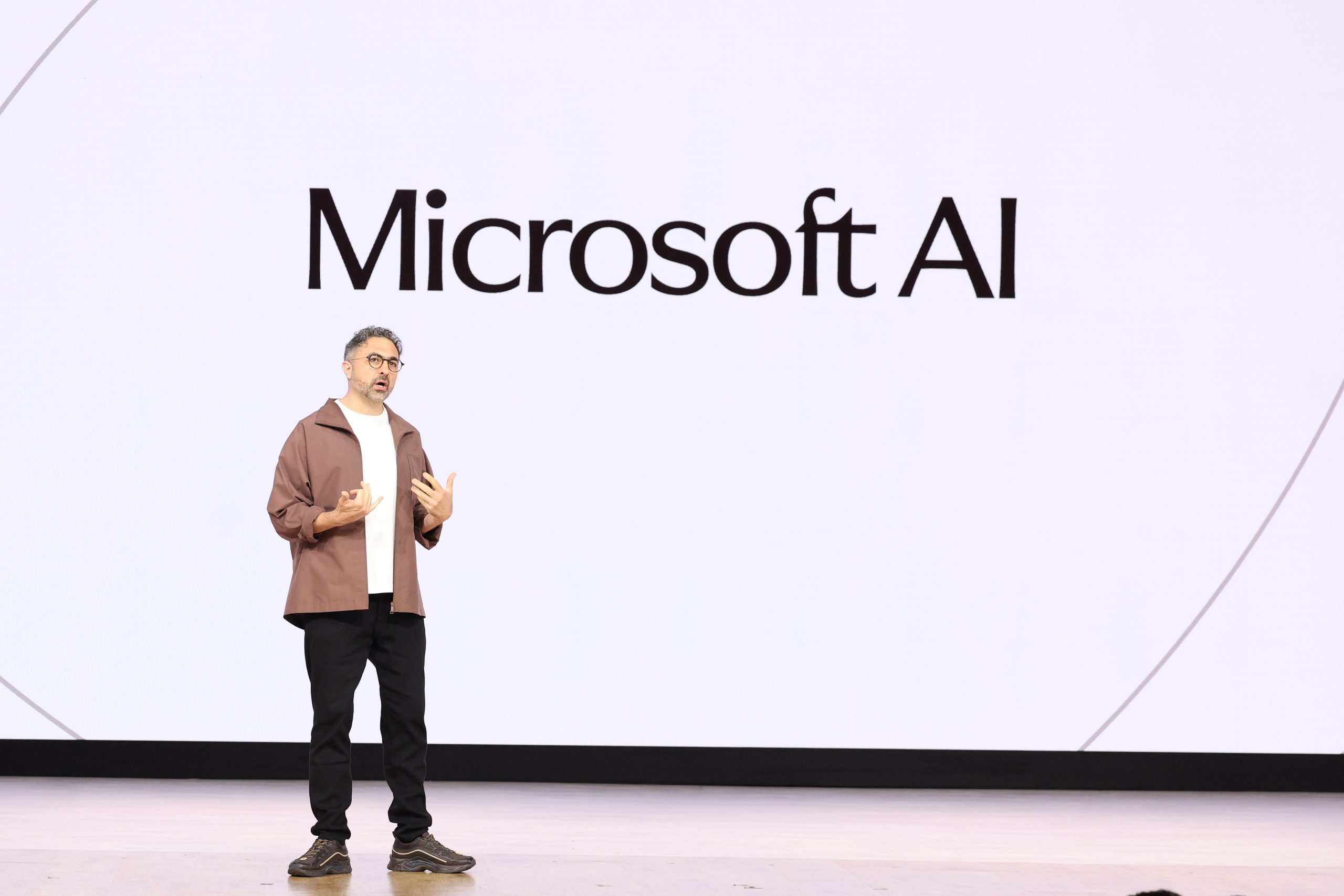 A man stands on a stage addressing a crowd