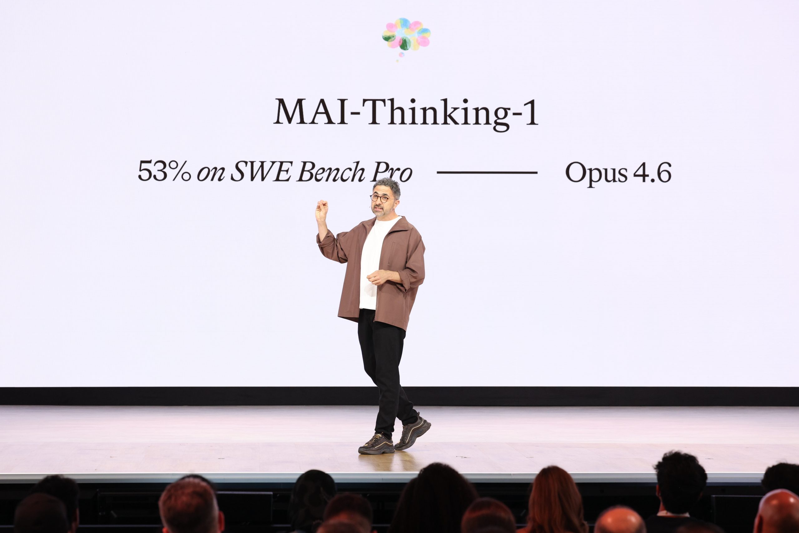 A man stands on a stage addressing a crowd