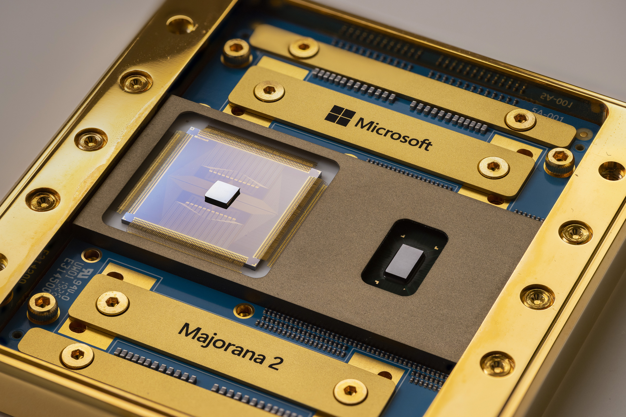 A mostly gold-colored chip with bits of blue showing. The names "Microsoft" and "Majorana 2" are visible.