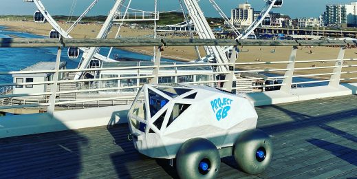 BeachBot sits on a raised boardwalk at Scheveningen Beach with the Ferris wheel in the background