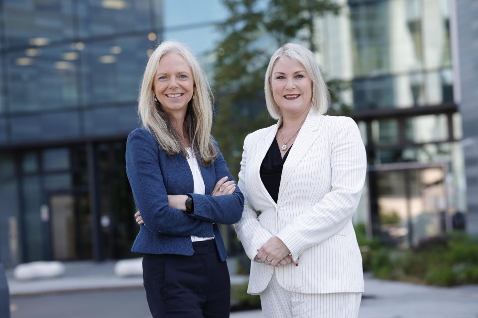 two people standing in front of microsoft ireland building